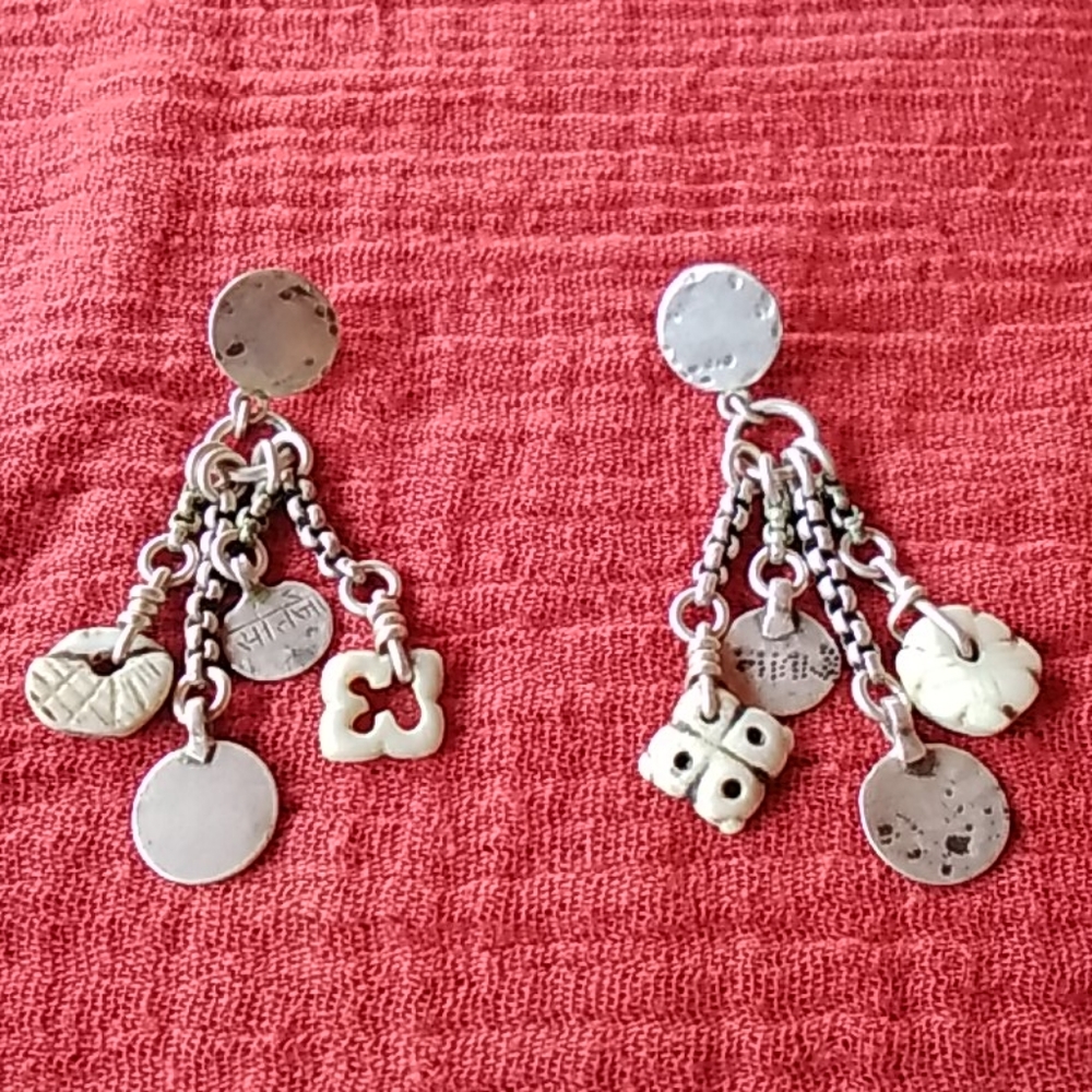 Artisan made dangling charm earrings.